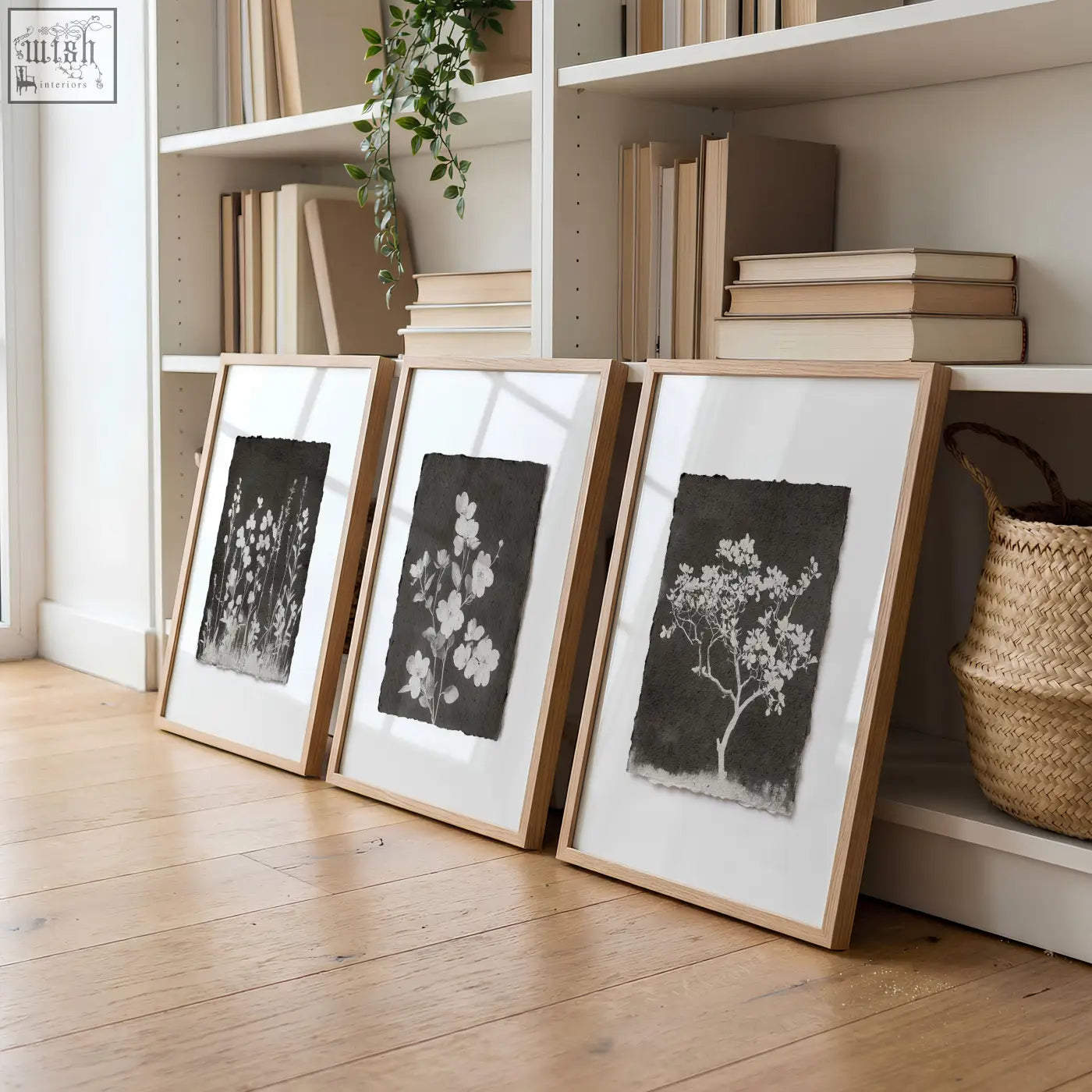Three framed black and white french country botanical wall art prints in light wood frames for living room decor