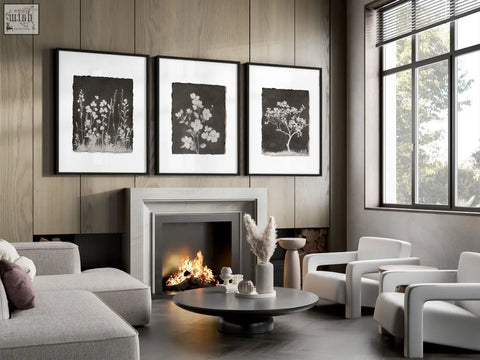 Black and white french country botanical wall art set of 3 in sleek frames above modern living room fireplace