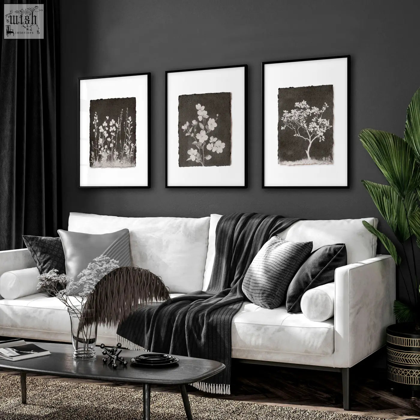 White sofa with black and gray pillows and dark gray blanket in living room featuring french country botanical wall art set of 3
