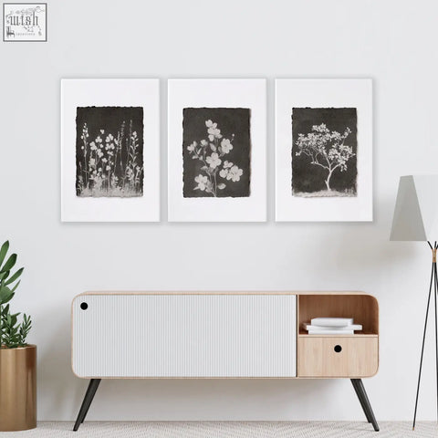 Modern minimalist sideboard with white ribbed panel and light wood accents in a living room with french country wall art