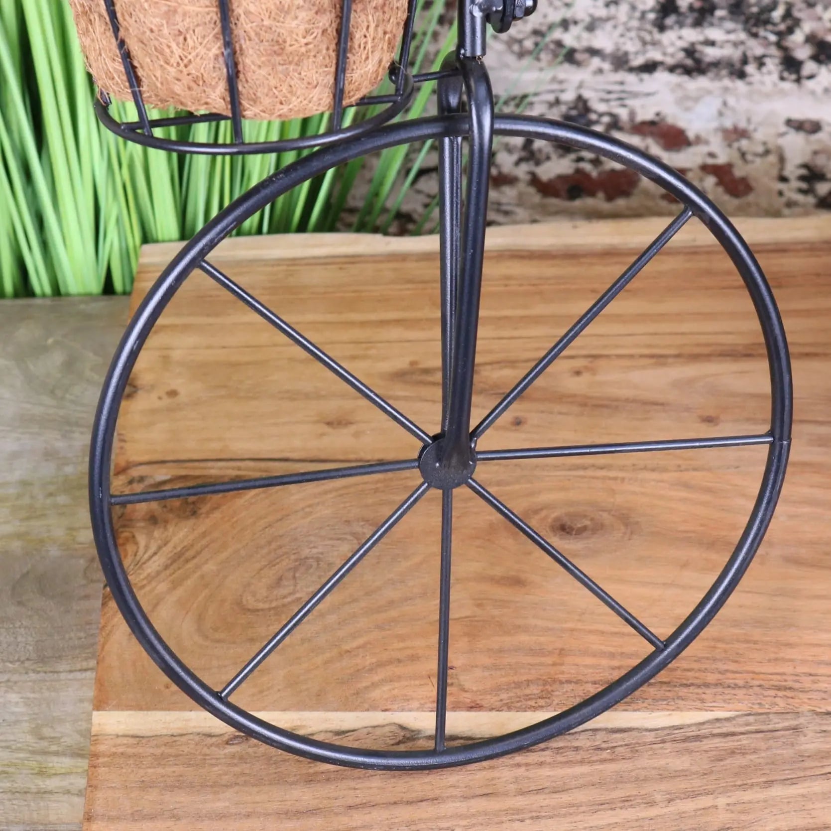 Black metal bike garden planter with woven coconut fiber basket perfect as a vintage garden planter