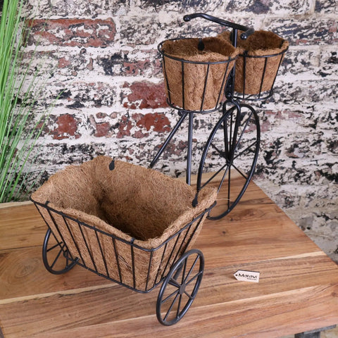 Black metal bike garden planter with three coconut fiber-lined baskets perfect for outdoor garden planter use