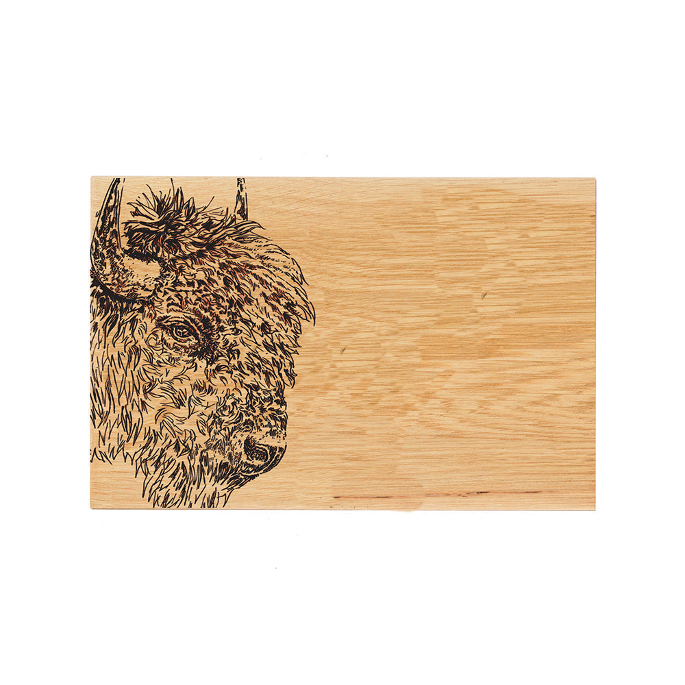 A rectangular oak serving and cheese board with a dark brown engraved bison oak head on the left side
