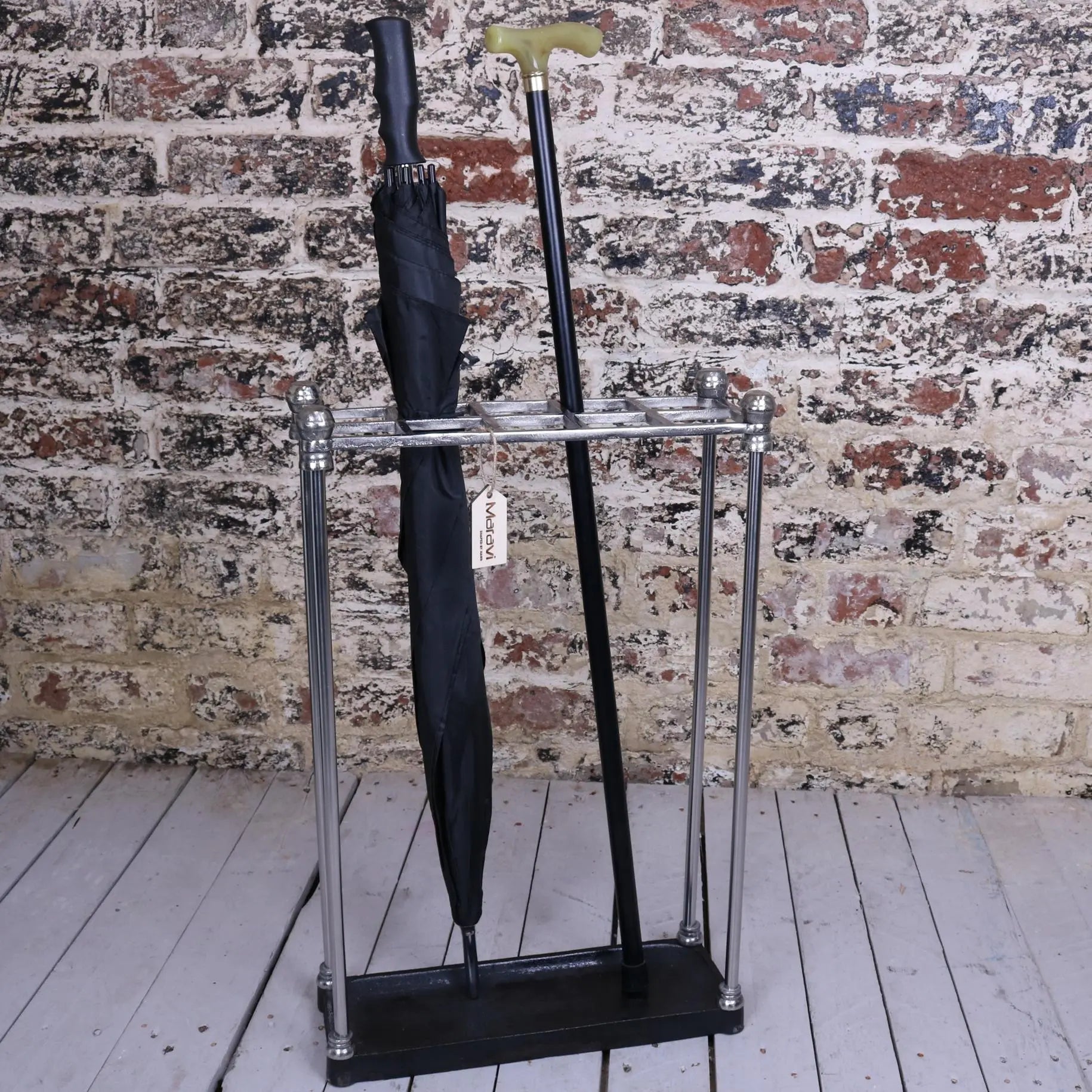 Bitlan rectangular walking stick stand with chrome metal finish and black base holding a black umbrella and walking stick