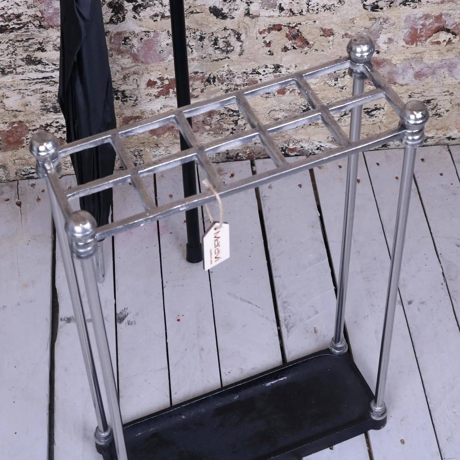 Bitlan rectangular walking stick stand made of chrome-plated metal with decorative ball finials and black rubber base