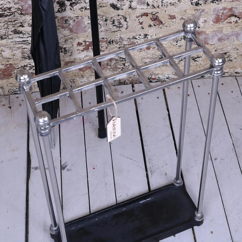 Bitlan rectangular walking stick stand made of chrome-plated metal with decorative ball finials and black rubber base