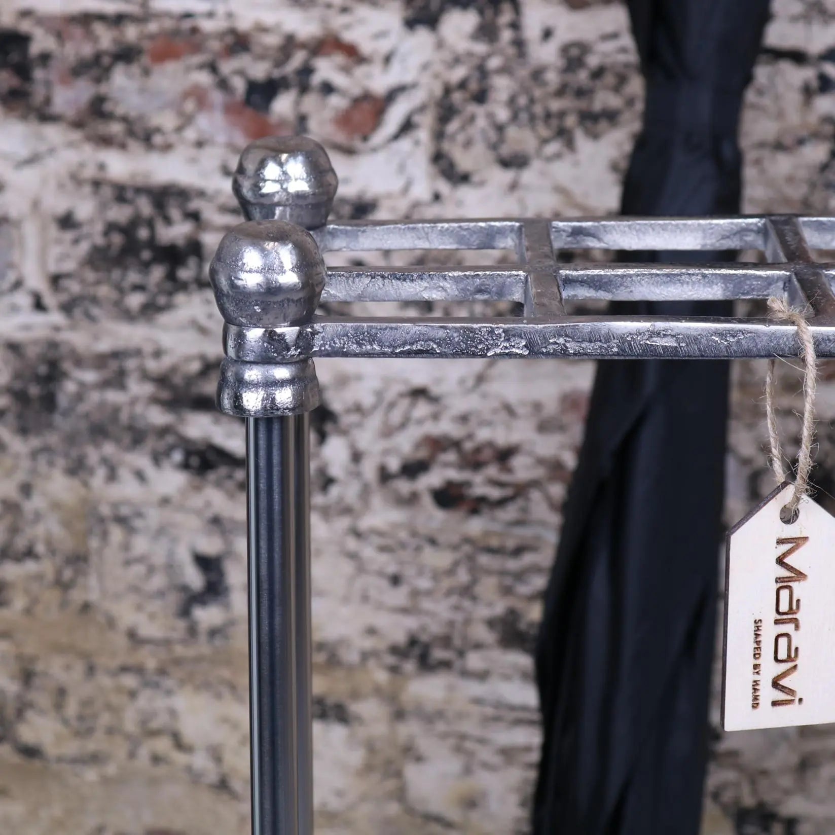 Silver-finished metal bitlan rectangular walking stick stand with rounded ball finials and rustic industrial design