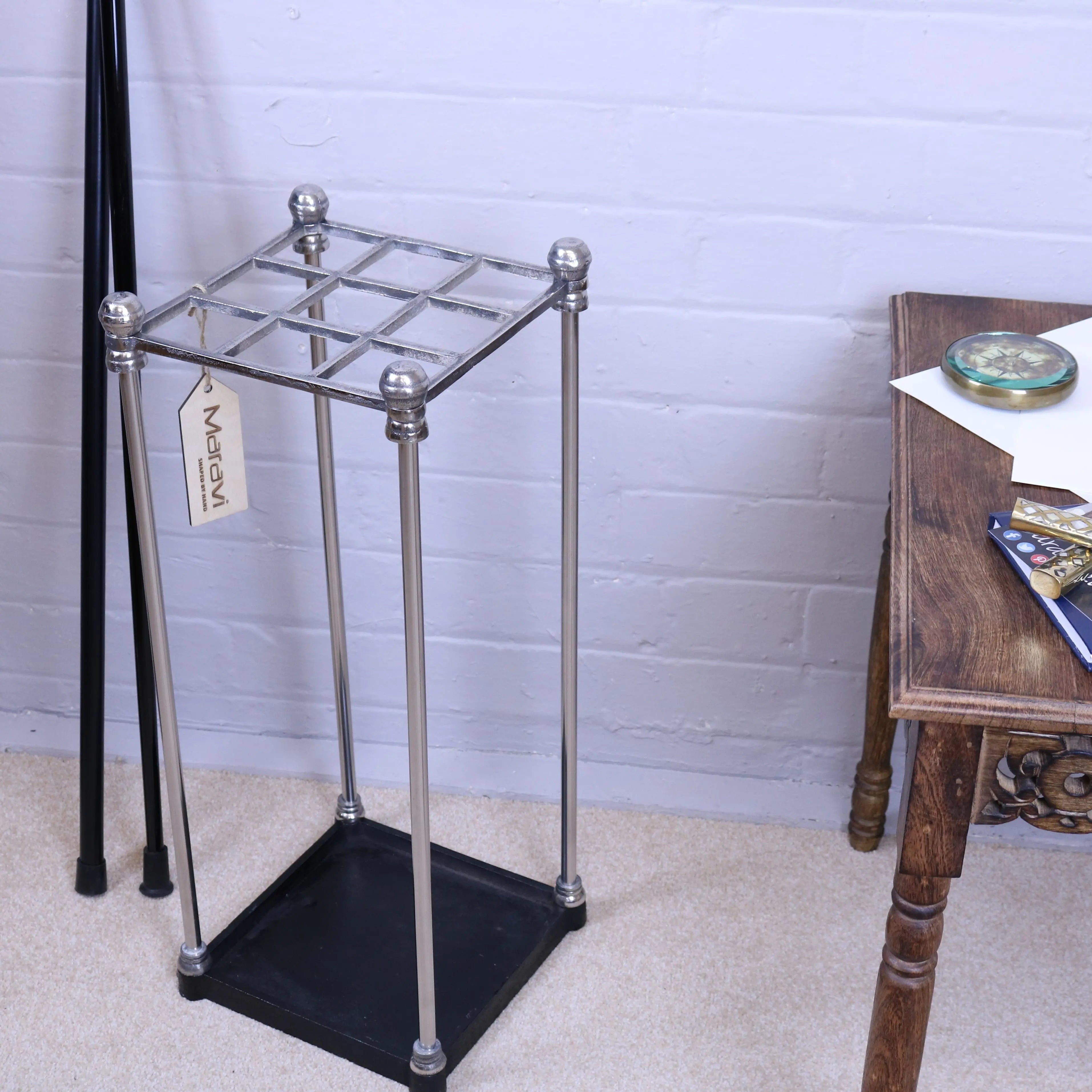 Silver-finished metal bitlan walking stick stand with black base and decorative ball caps for walking sticks storage