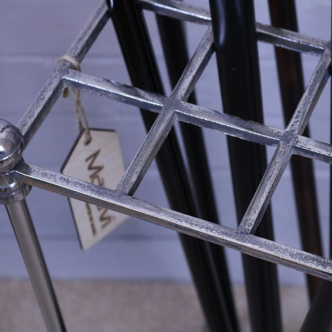Silver metal bitlan walking stick stand with grid design and rounded corners for holding walking sticks