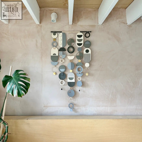 Modern hand painted wall art featuring layered circular shapes in muted blues greys white with gold accents
