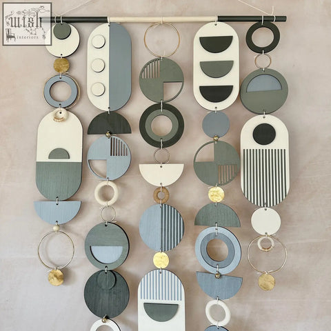 Modern geometric wall art hand painted with layered wooden shapes in black grey white and gold accents for stylish decor