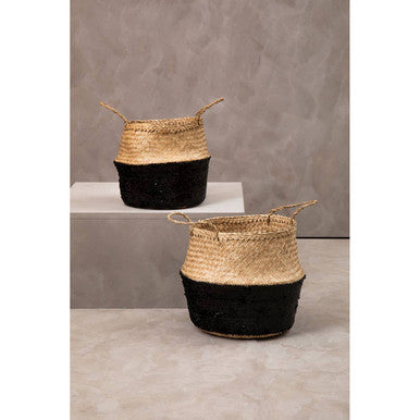 Two woven natural medium seagrass baskets with beige upper half and black lower half with matching handles