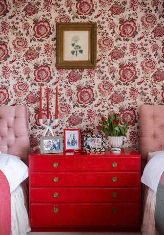 Vibrant red dresser with gold knobs next to black and white marquetry striped photo frame 7x5 inches