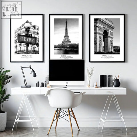 White minimalist desk with slender metal legs paired with black and white paris wall art set of 3 prints