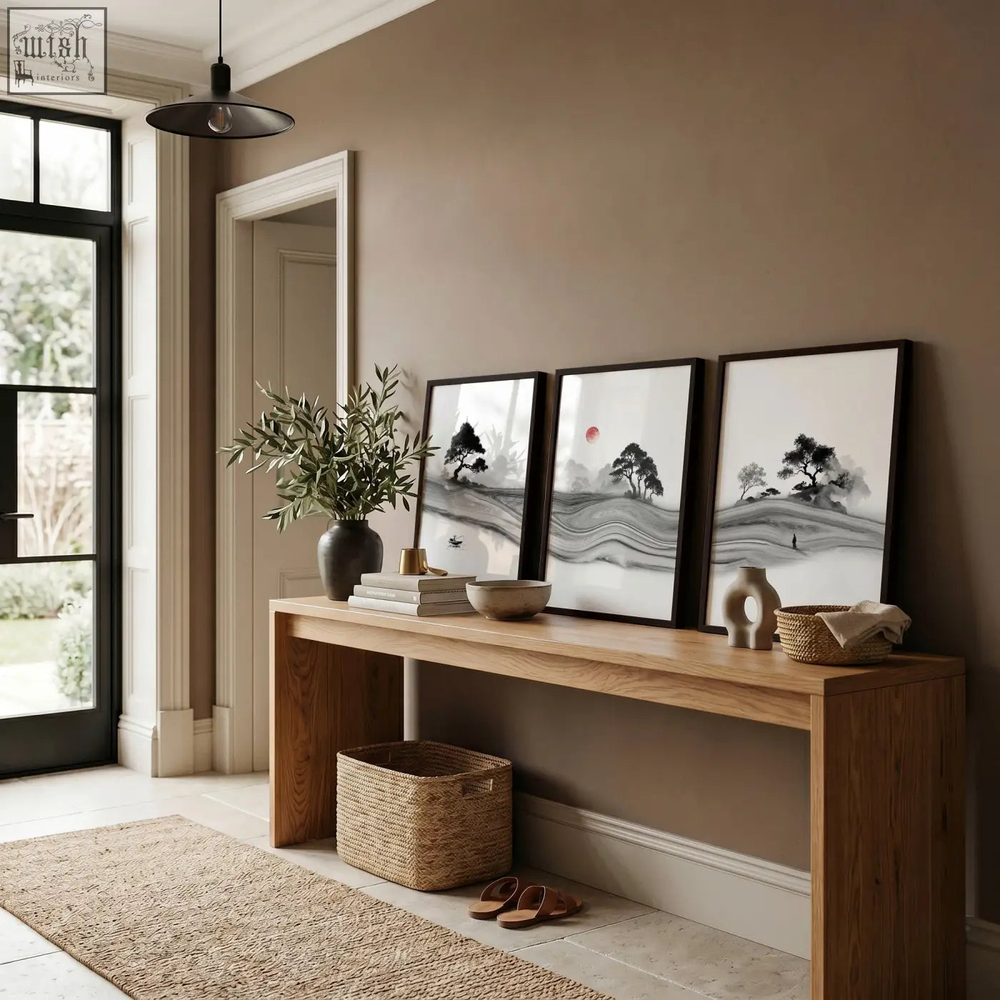 Three framed black and white prints japandi ink landscape with minimalist trees mountains and a red sun on wood table