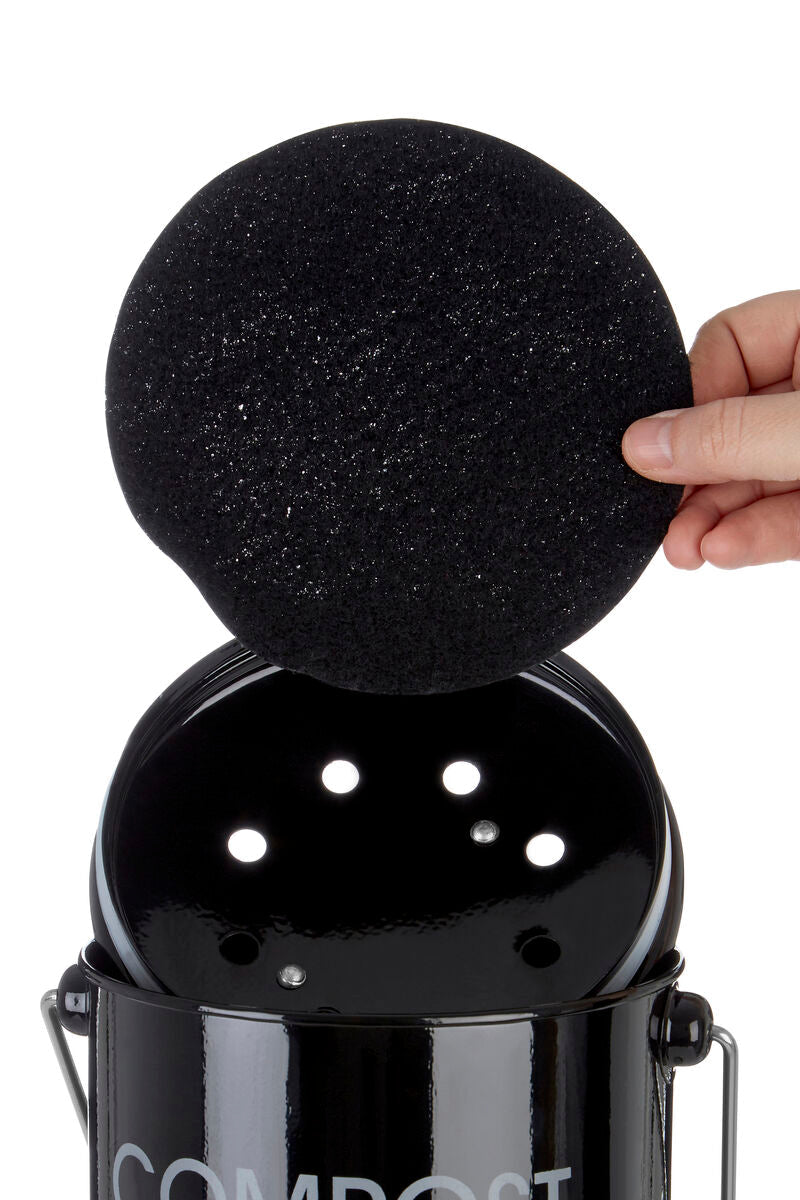 Black compost bin with handle showing a black circular sponge being lifted from inside the compost bin