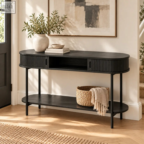Black fluted console table with sliding storage shelf featuring ribbed sides and slender legs in black finish