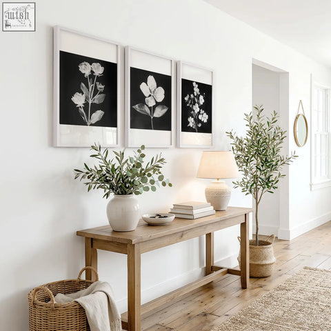 A black framed picture featuring a white ceramic vase with eucalyptus branches in french country botanical style