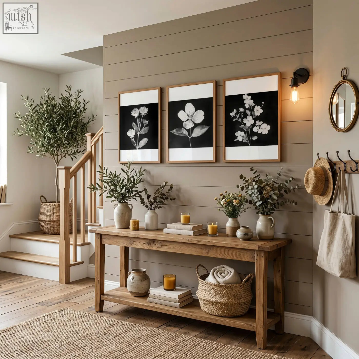 Rustic wooden console table with natural finish and two shelves holding vases and baskets beneath black framed picture set of 3