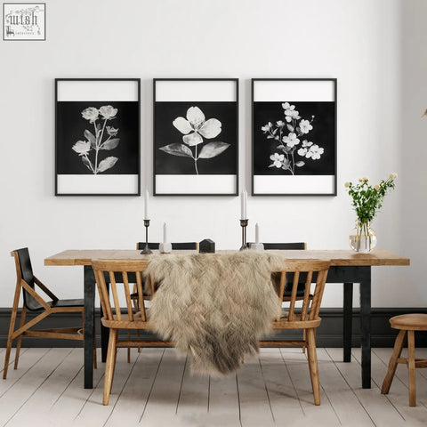 Set of three black framed french country floral prints in minimalist frames displayed above dining room table wall art