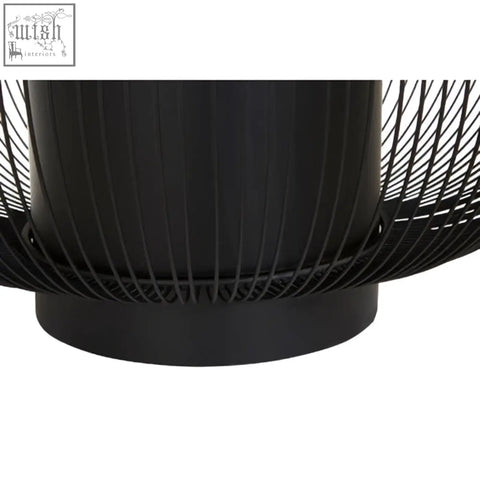Black glass top round coffee table with matte black cylindrical wireframe base and fire pit style wire mesh enclosure trento coffee table