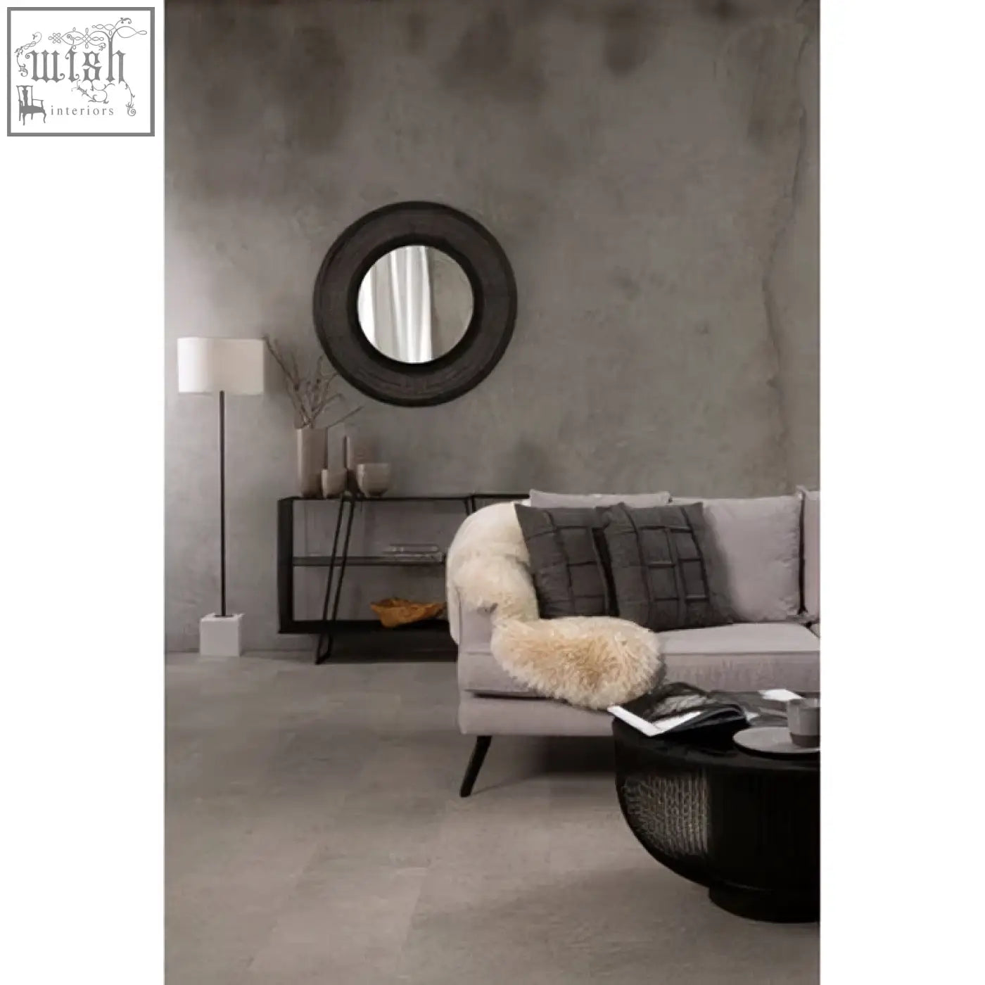 Circular black-framed mirror above the black glass top round trento coffee table with matte black wireframe base