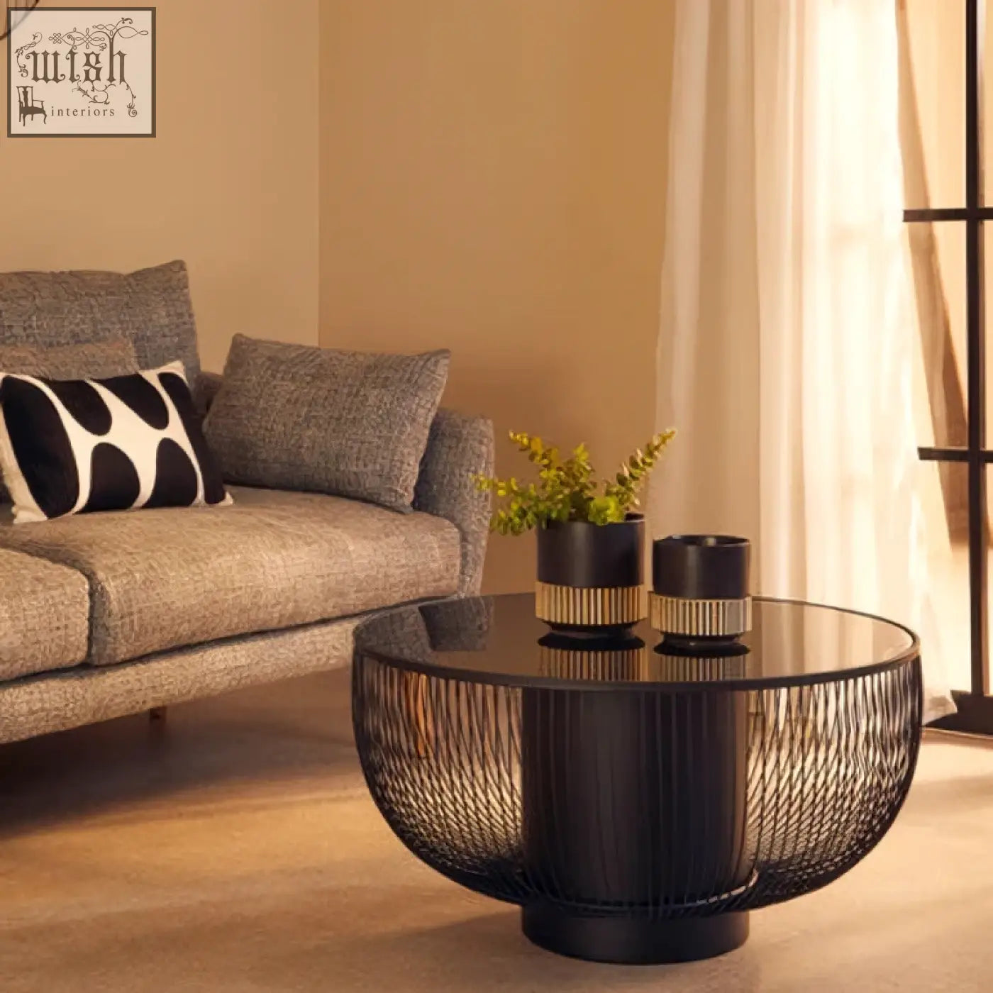 Black glass top round coffee table with matte black cylindrical wireframe base trento coffee table design