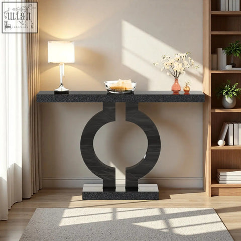 Modern black marble console table with sleek circular base perfect as a sculptural entryway or sofa table