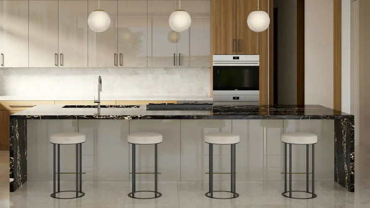Black marble kitchen island with white bar stools and modern pendant lights.