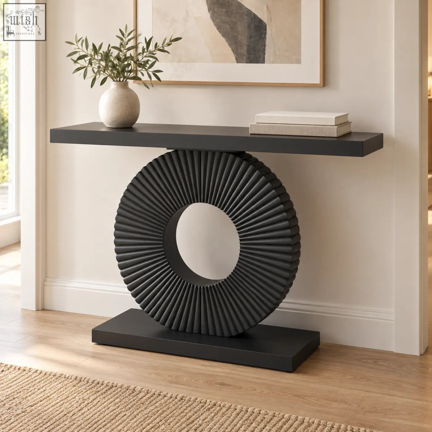 Black sculptural fluted console table with a circular ribbed base and flat top surface perfect for entryways