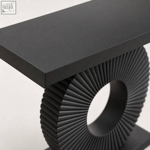 Black sculptural fluted console table with a matte top and a circular fluted base for stylish living spaces