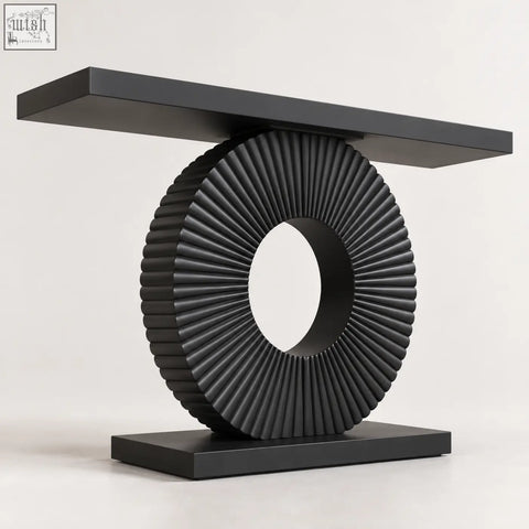 Black sculptural fluted console table with sleek ribbed circular base and minimalist rectangular top design