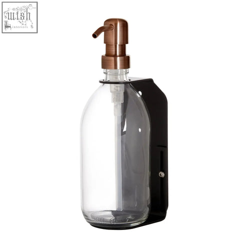Black single wall mounted soap dispenser with a refillable glass bottle copper pump and stainless steel bracket