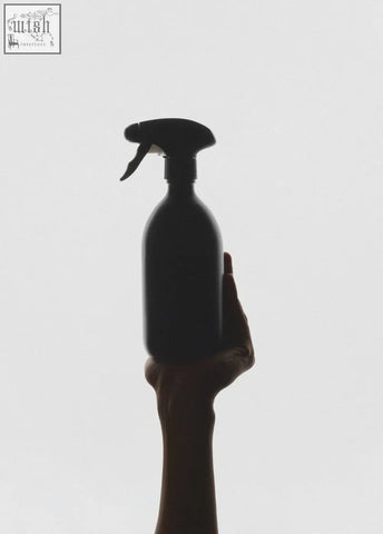 Hand holding a black spray bottle designed for easy use and durable spray performance