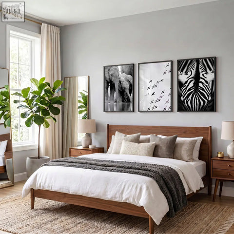 Wooden bed with natural finish, pillows, dark gray throw, alongside black white photography prints of african wildlife set of 3