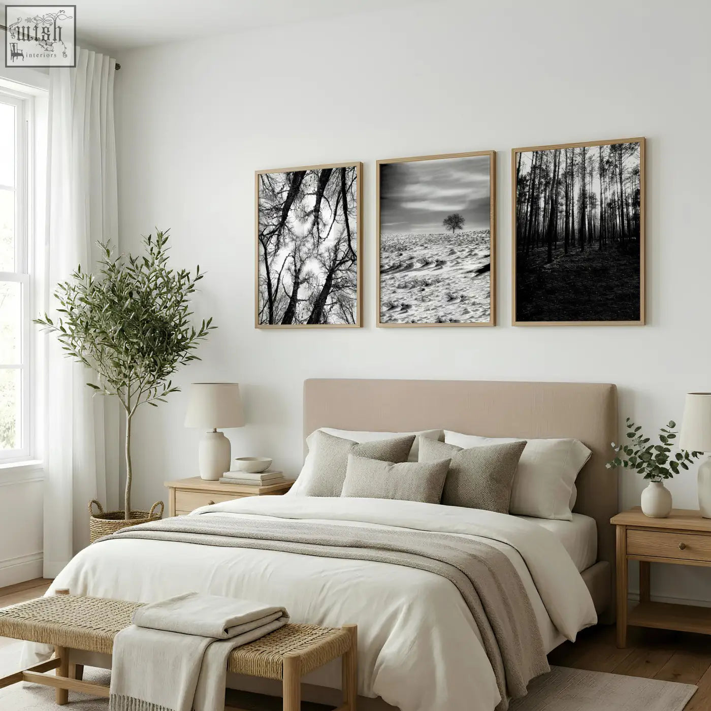 Three framed black white photography prints with winter nature landscapes in light wood frames above a bed wall art set