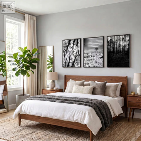 Wooden bed with natural finish, multiple pillows, dark gray throw blanket, black white photography winter landscape prints set of 3