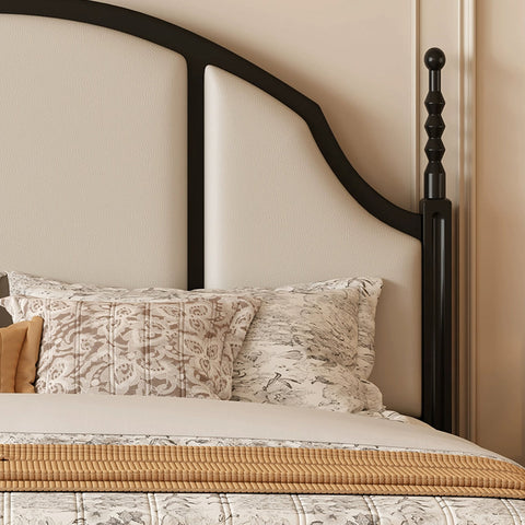 A sleek black metal blanche king size bed frame with curved headboard upholstered panels and elegant turned posts