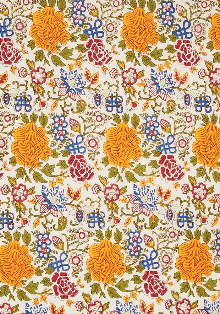 Vibrant blooming spring tablecloth with bold yellow red and blue blossoms on cream fabric perfect for spring decor