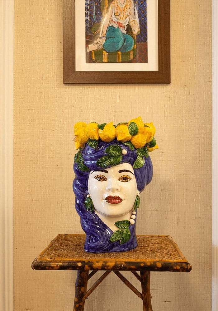 Blu lemon bust statue ceramic vase shaped like a woman’s head with purple hair yellow flower crown and green leaves