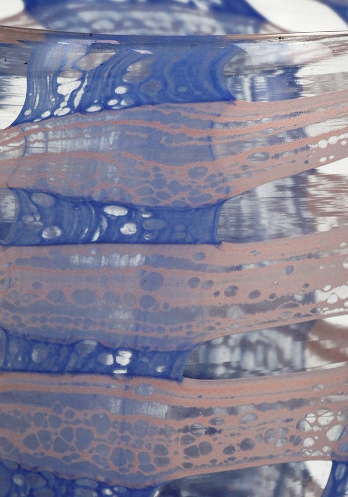 A translucent glass candle holder vase with flowing blue and peach marbled patterns called blue affect