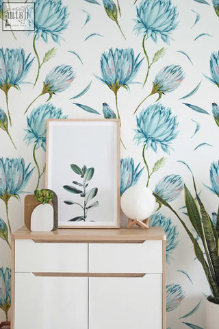 Minimalist white-framed botanical print with green leaf illustration on peel and stick wallpaper for living space decor