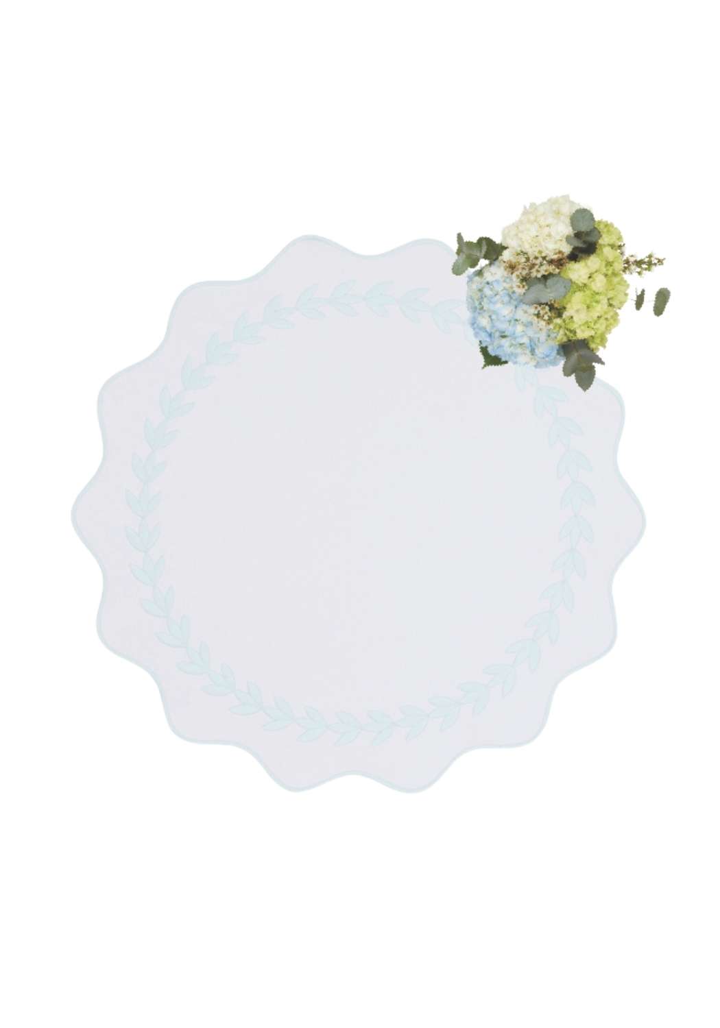 A delicate white plate with a light blue rim and floral corner on blue garland placemats set of 4
