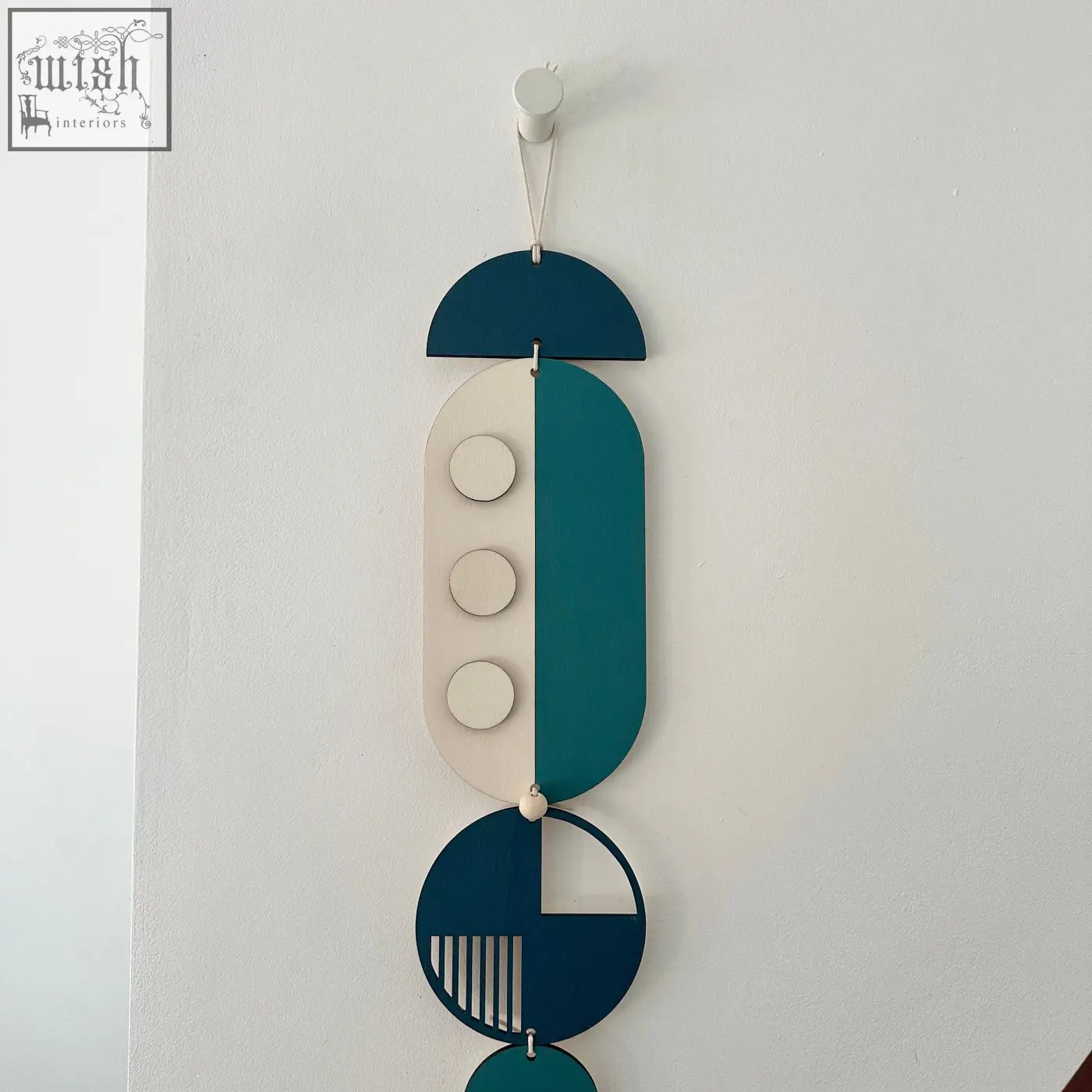 Modern wall art featuring layered teal cream and dark blue geometric wood shapes with minimalist cutouts for home decor