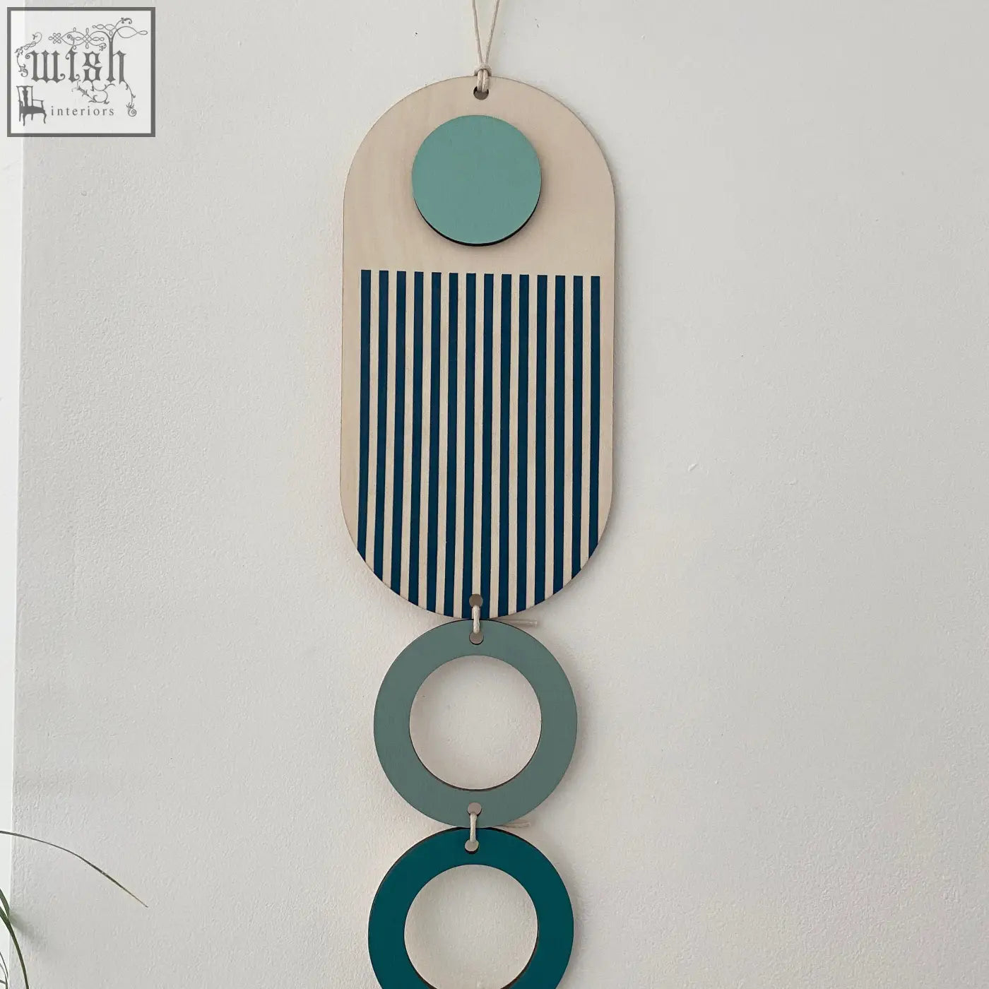 Modern wall art with light wood base, teal and navy stripes, and green rings for minimal home decor