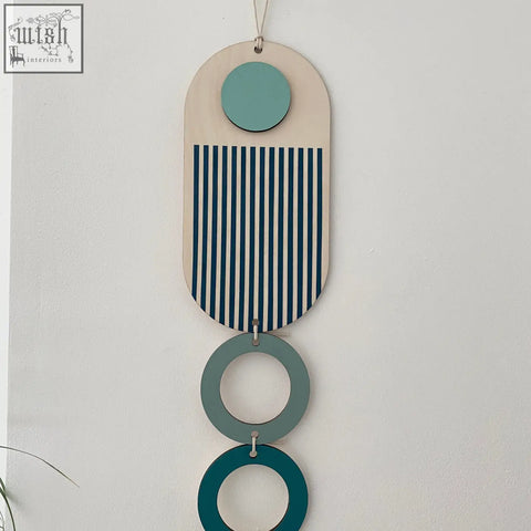 Modern wall art with light wood base, teal and navy stripes, and green rings for minimal home decor
