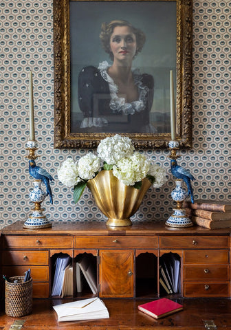 Blue parrot decorative tall candle holder 40 cm with gold leafed vase filled with white hydrangeas