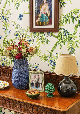 Blue pineapple large stoneware vase in blue woven design holding a bouquet of colorful flowers