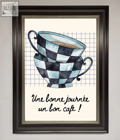 Watercolor framed wall art of a blue teacup stack with black and light blue checkered pattern in dark wood frame