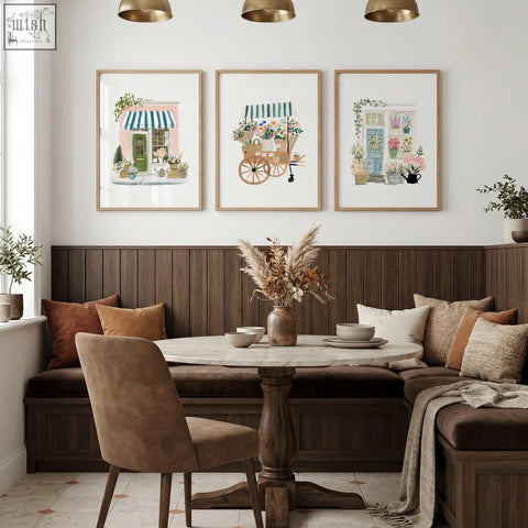 Round marble-top dining room table with dark wood pedestal base next to blue wall art flower shop canvas set of 3